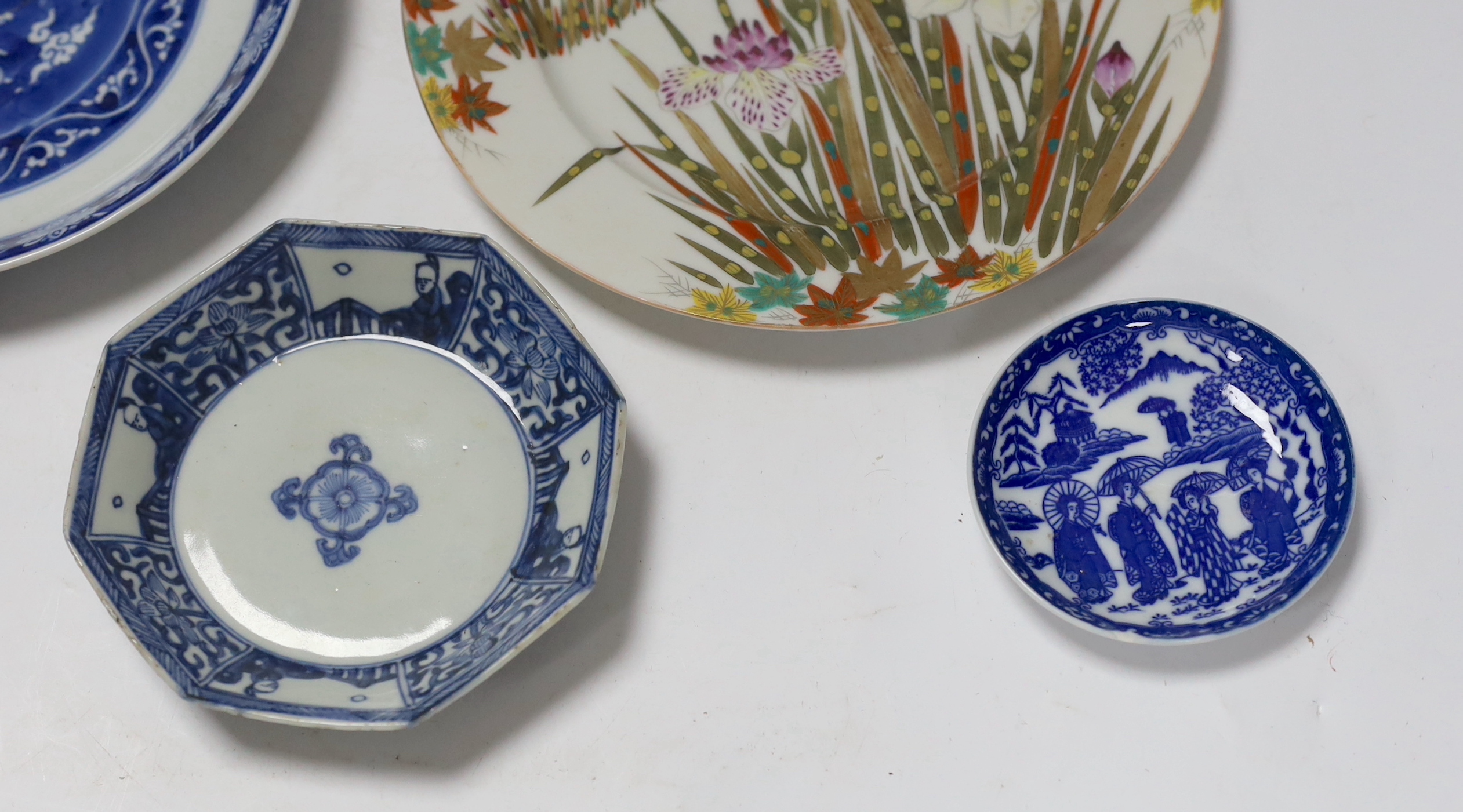 A group of 18th century Chinese porcelain plates and saucers, mostly blue and white and an octagonal famille rose example, together with three Japanese dishes, largest 27cm in diameter